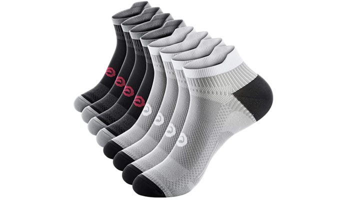 a line of four pairs of black and grey and black and red compression socks