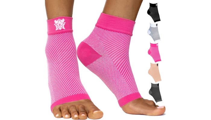 A person wearing bright pink compression sleeves with five other color options displayed to the right.