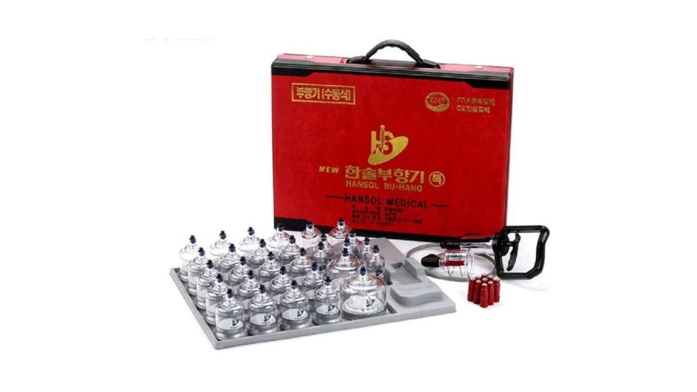 a cupping set with 30 total pieces; cups are lined up by the box and accessories