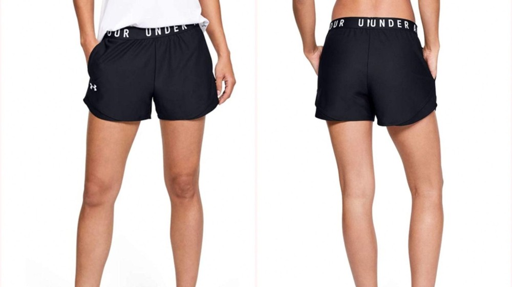 woman wearing black pair of athletic shorts with "Under Armour" on the waistband