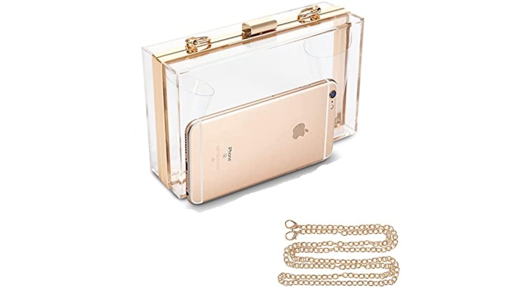 hard-bodied clear clutch bag with gold chain strap beside cellphone 