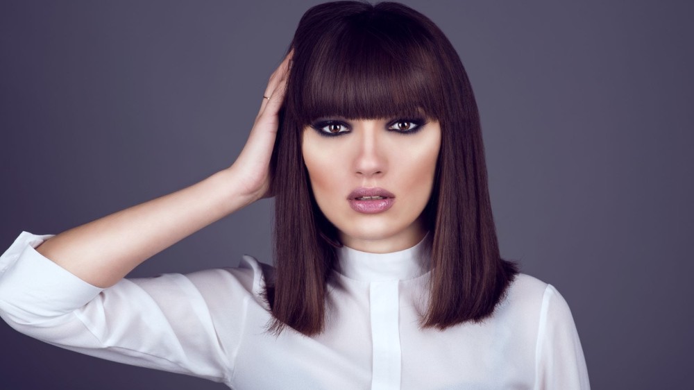 A brunette woman with a square face and a long, sleek haircut. 