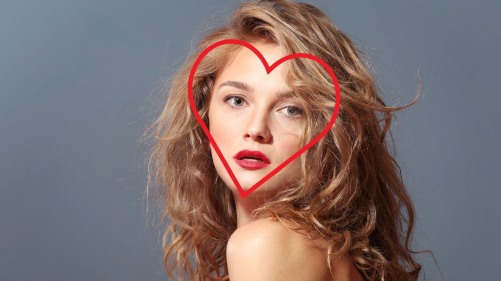 A woman with a heart-shaped face and long layers.