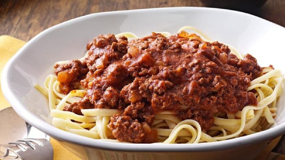 a plate of spaghetti toppe with homemade sauce.