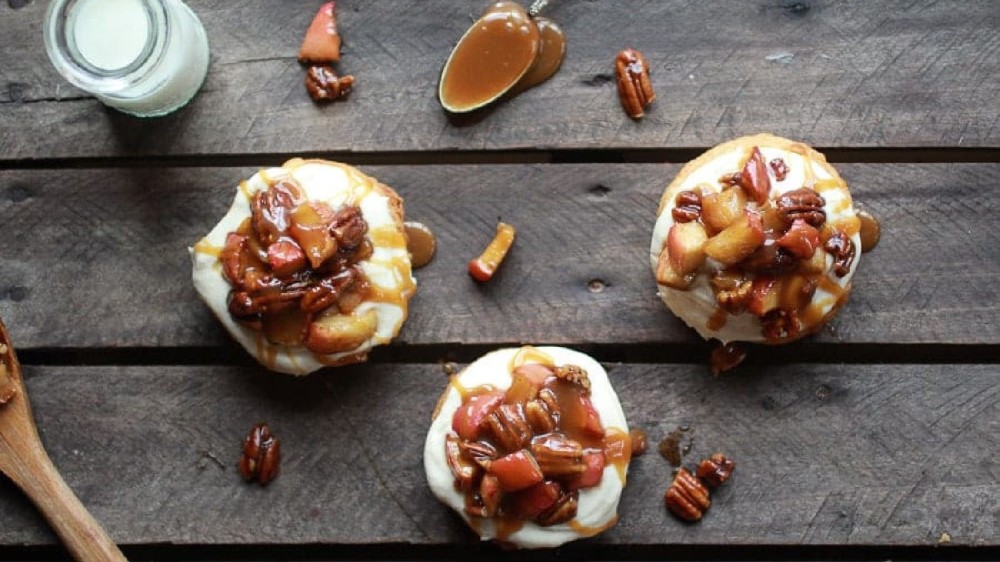 Three cronuts toppe with caramel, pecans and warm apples. 