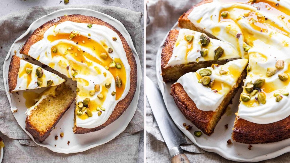 An orange almond cake toppped with yogurt, honey, and pistachios