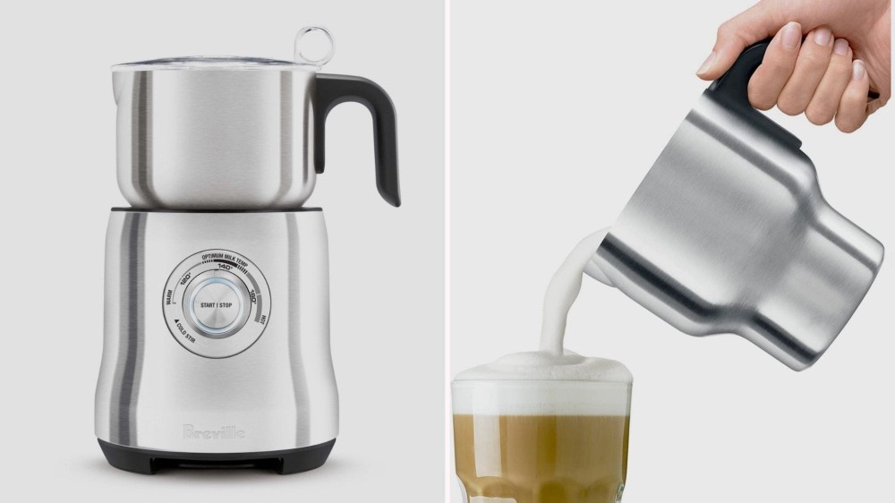 A silver milk frother; a hand pouring frothed milk into a cup of coffee