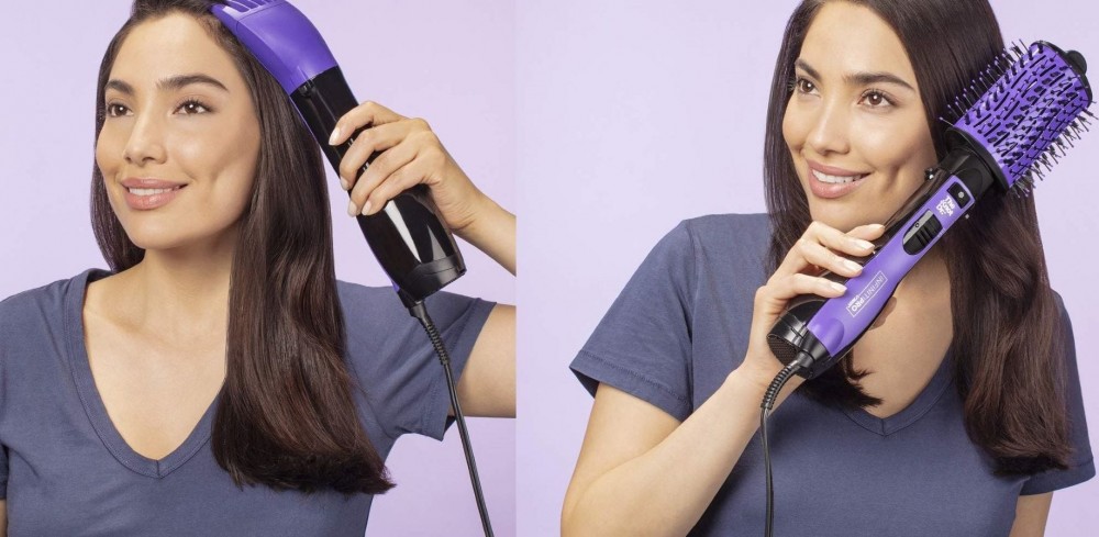 A woman using The Knot Dr. attachments to brush and style her hair.