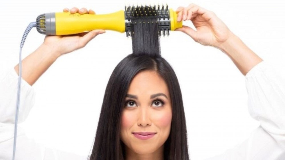 A woman using the Drybar Double Shot.