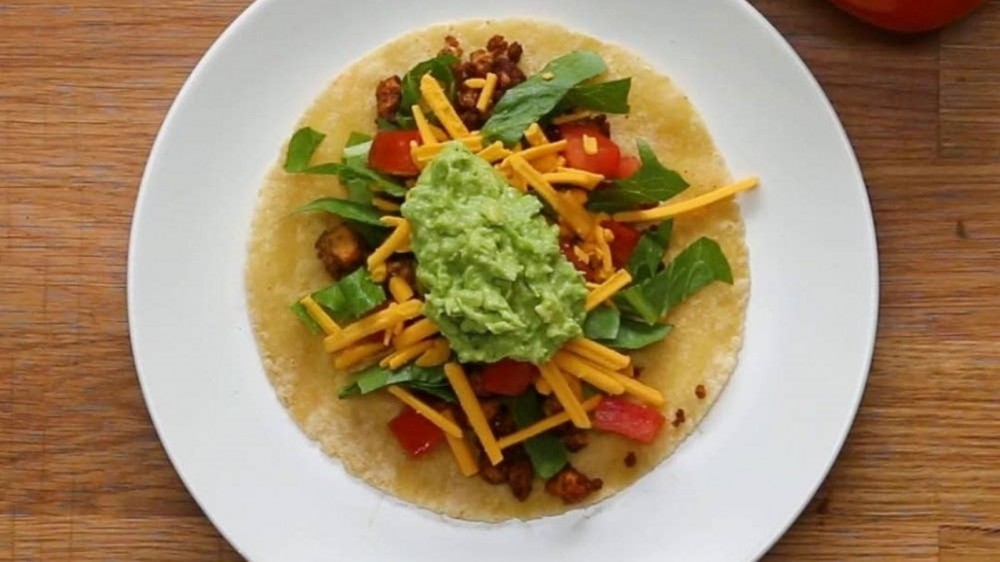 Tofu taco fillings on a soft tortilla. 