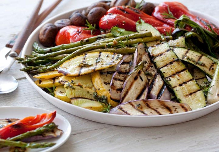 A gorgeous arrangement of grilled vegetables including zucchini, yellow squash, bell peppers, asparagus and mushrooms.