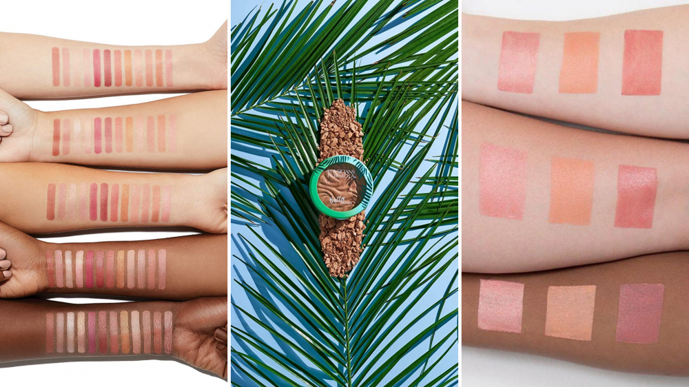 Arms are swatched with blush shades and a bronzer sits on palm fronds.