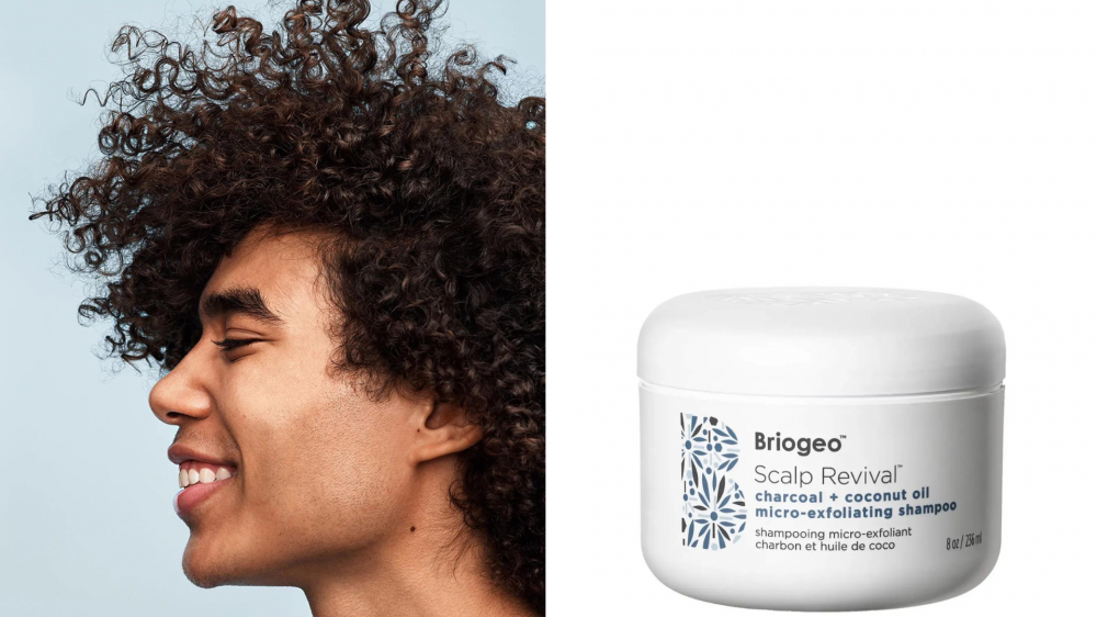 A person has curly hair, and a tub of Briogeo shampoo sits on a plain background.