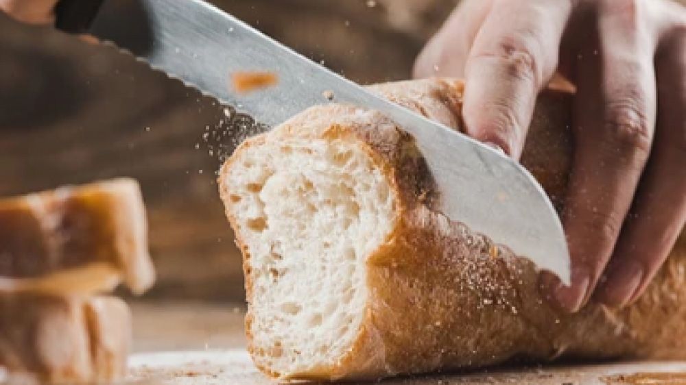 A close up of slicing bread.