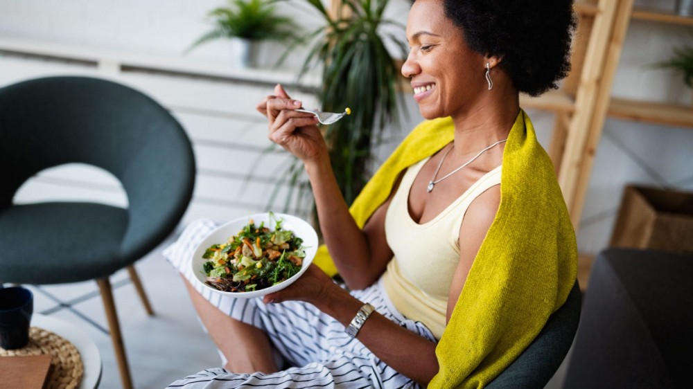 Woman eating a salad.