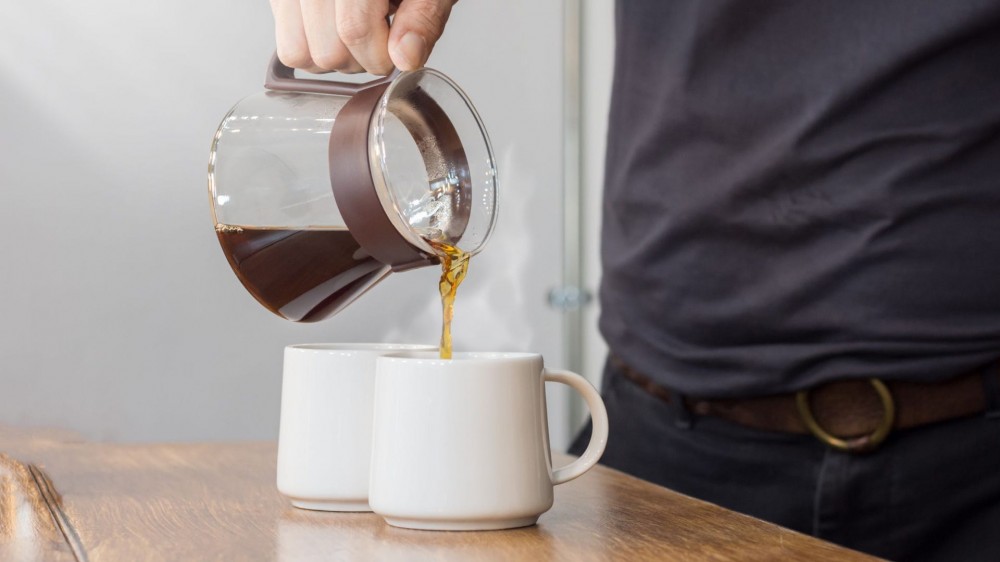 Someone pours a cup of coffee