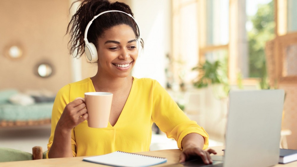 A woman drinks coffee at a coffee shop