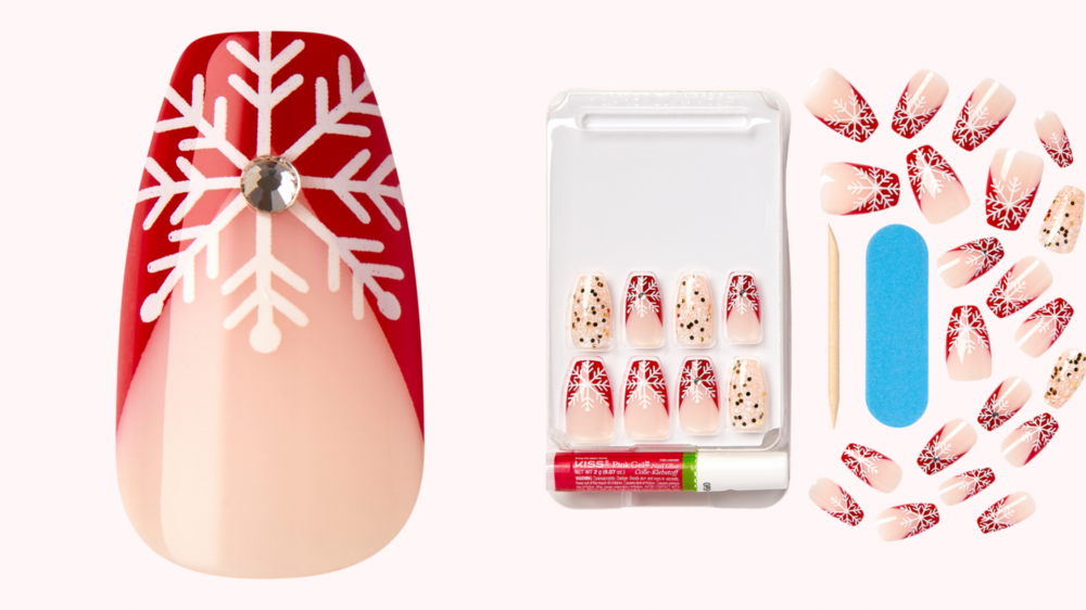 A press-on nail features a snowflake pattern on top of a red tip.