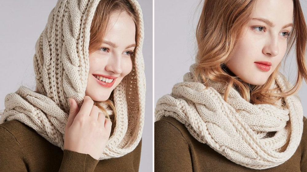 A woman models a chunky cream knit scarf on her head and around her neck.