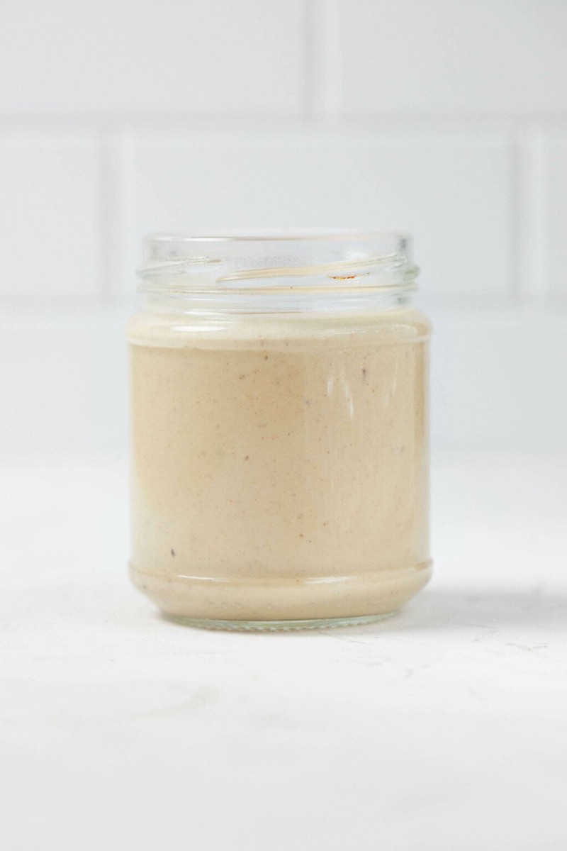 An overhead image of a creamy balsamic Dijon tahini dressing.